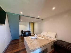 a room with a bed with a towel on it at Anaya Beach Resort - Siargao in General Luna