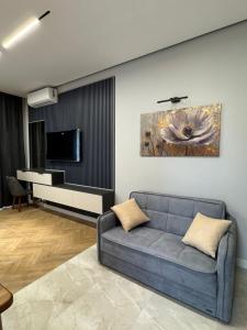 a living room with a couch and a piano at Sea breeze in Nardaran