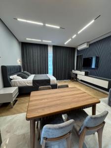 a living room with a bed and a wooden table at Sea breeze in Nardaran +8 photos