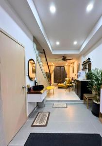 a hallway with a door and a living room at LYLAC Home Saigon NTMK - City Center Spacious Modern Townhouse Roof Terrace in Ho Chi Minh City +59 photos
