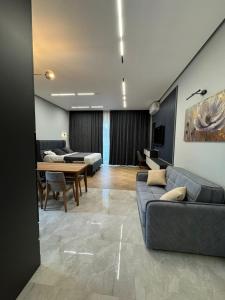 a living room with a couch and a dining room at Sea breeze in Nardaran