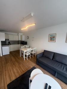 a living room with a blue couch and a table at Rozenhof - Appartement au coeur d'Armentieres in Armentières