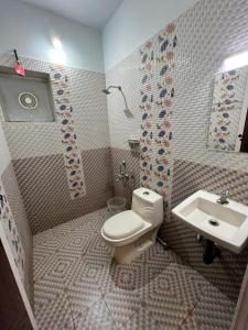 a bathroom with a toilet and a sink at Confident Residency in Guruvāyūr
