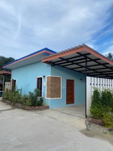 a blue building with awning in front of it at จันผารีสอร์ท By NLG  +2 photos