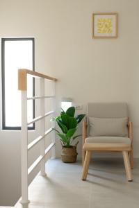 a living room with a chair and a plant at 青日所 Midoriya in Tainan