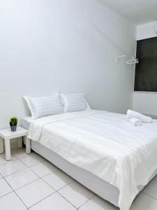 a white bedroom with a large bed with white sheets at POP Stay 泊居 Sungai Bakap Jawi in Kampong Gurun