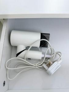 a white desk with a roll of paper and cables at POP Stay 泊居 Sungai Bakap Jawi in Kampong Gurun
