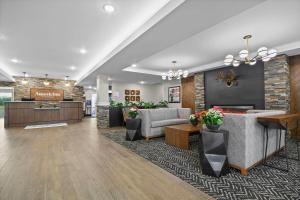 a lobby with two couches and a reception desk at AmericInn by Wyndham International Falls in International Falls