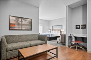 a living room with a couch and a bed at AmericInn by Wyndham International Falls in International Falls