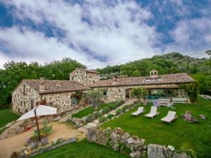an exterior view of a stone house with a yard at Villa Solace - Comfort Charm in Guardea +32 photos