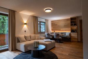 a living room with a couch and a table at Fürmesli Appartements in Lech am Arlberg