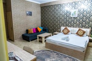 a hotel room with two beds and a couch at Sebail Inn Hotel Badamdar in Baku +33 photos