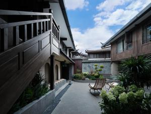 a courtyard with two chairs and a building at Lijiang Old Town Moju Homestay, Sifang Street Branch in Lijiang