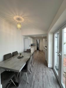 a dining room and kitchen with a table and chairs at 3 bed Spacious House with Parking in Worthing