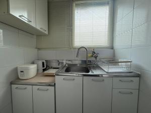 a kitchen with a sink and a counter top at 대치동 좋은방 in Seoul +23 photos
