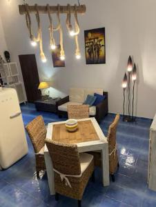 a living room with a table and chairs at Casa Ada - Incantevole loft in centro in Lampedusa
