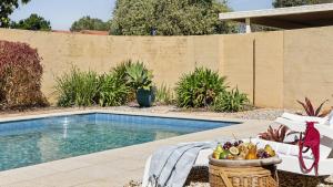 a swimming pool with a basket of fruit next to it at Point Paradiso - Glorious waterfront in Yamba