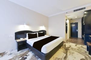a bedroom with a large bed in a room at Sunday Malacca Formerly Tun Fatimah in Malacca
