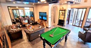 a large living room with a pool table in it at POTTERLAND Luxury Pool Villa Pattaya Walking Street 6 Bedrooms in Pattaya South +38 photos