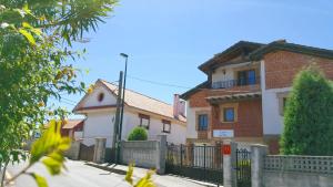 a house with a fence in front of it at Apartamentos Copi Villa de Suances in Suances