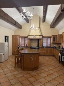 a large kitchen with wooden cabinets and a table at Stunning Waterfront House on Lough Currane Shores in Waterville