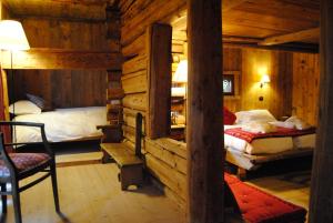 シャンポルクにあるFrantze, Le Rascard 1721のログキャビン内のベッドルーム1室(ベッド2台付)