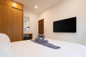 a bedroom with a bed with a towel on it at Luxury Tropical Villa Samui - Shira in Koh Samui  +11 photos