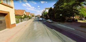 a street with cars parked on the side of the road at Central Residence in Mediaş