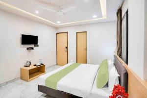 a bedroom with a large bed and a television at The Byke Express - Near Gopur Square in Indore +13 photos