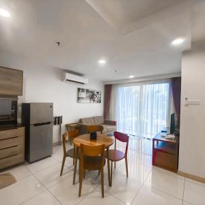 a kitchen and dining room with a table and chairs at Timurbay Residences in Kuantan