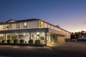 a hotel building with a parking lot in front of it at Super 8 by Wyndham Terre Haute in Terre Haute