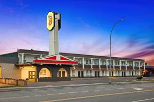 a building with a clock tower in the middle of a street at Super 8 by Wyndham Thunder Bay in Thunder Bay
