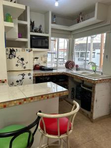 a kitchen with a counter and a sink and a chair at Departamento 3 tecalai San Carlos, Sonora in Rancho El Pozo