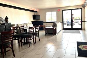 a restaurant with a dining room with a table and chairs at Super 8 by Wyndham Madison IN in Madison