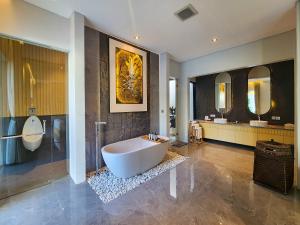 a large bathroom with a tub and two sinks at Villa Narda Seminyak by Nagisa Bali in Legian +47 photos