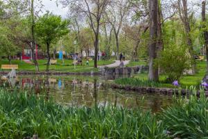 a park with a pond and benches and trees at Large apartment by the Opera- luxury living room, 2 bedrooms, equipped kitchen and balcony in Yerevan