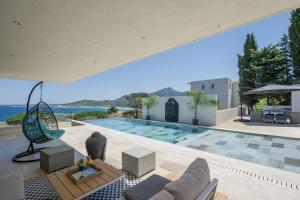 a villa with a swimming pool and a view of the ocean at Villa Mizar in Algajola