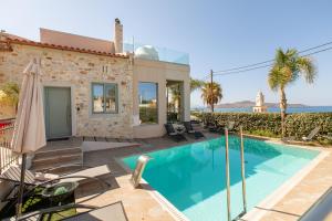 a villa with a swimming pool and a house at Superior Villa Kleanthi in Stalos