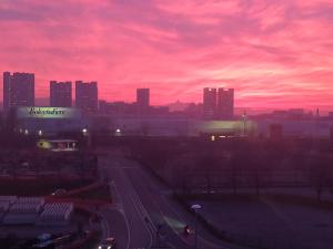 a view of a city with a red sky at The Sydney Hotel in Bologna