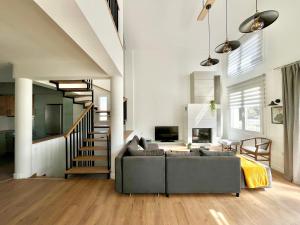 a living room with a couch and a staircase at Πράσινο σπιτάκι in Kastoria