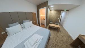 a bedroom with a large bed with white pillows at Mirasierra in Mancha Real