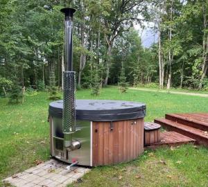 an outdoor grill with a stove top in a field at Sikana Mõisa saun in Sikana +5 photos