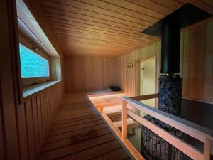 a sauna with a staircase in a wooden house at Sikana Mõisa saun in Sikana