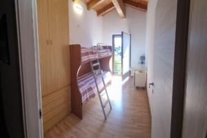 a small room with a bunk bed and a hallway at Residenza al Ponte in Arco