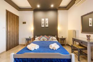 a bedroom with a bed with two towels on it at Seranides Boutique Hotel in Kato Gatzea