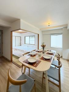a dining room with a table and a bed at Residence Yu by b hotel - Quiet & Cozy Apartments Steps from City Center in Hiroshima +104 photos