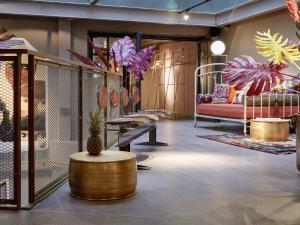 a room with several beds and a table with a pineapple at 25hours Hotel Terminus Nord in Paris