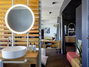 un baño con lavabo y espejo en 25hours Hotel The Circle, en Colonia 40 fotos más