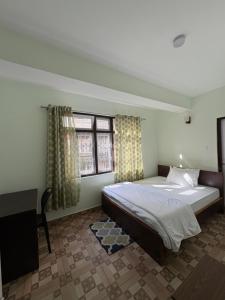 a bedroom with a large bed and a window at Lotus Zen Stay in Gangtok