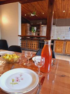 a table with a plate and a bottle of sauce at les quatres sources in Houffalize